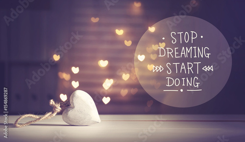 Stop Dreaming Start Doing message with a white heart
