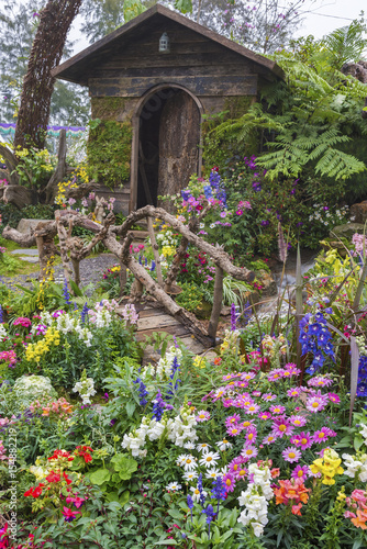 Landscaped backyard of old house with flower garden