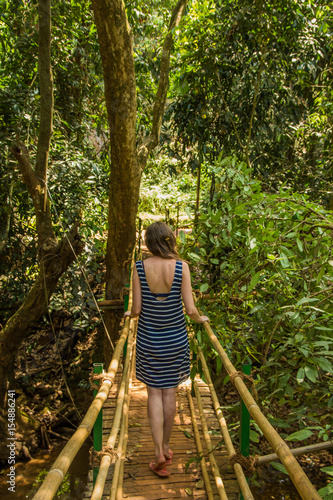 Young woman in the jungle on the bridge in tropical spice plantation, Goa, India