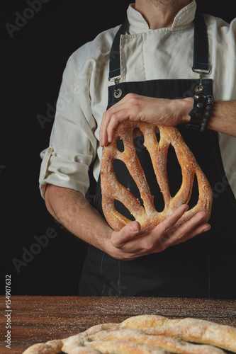 Hands men holding fougas bread photo