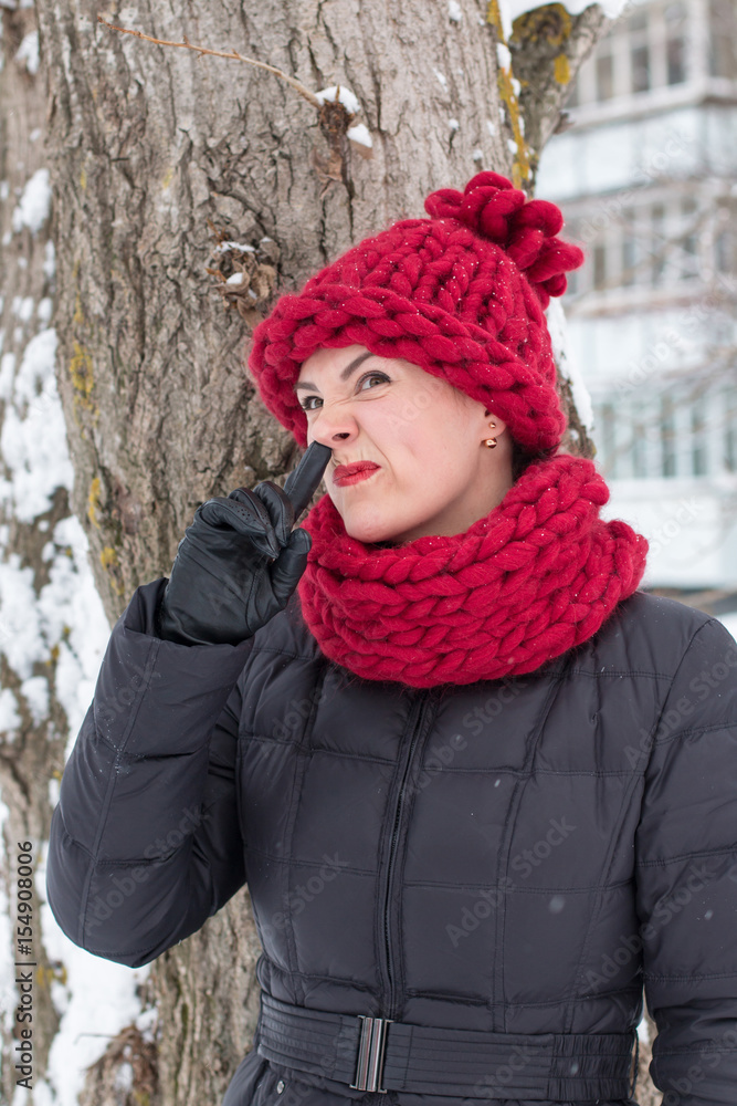 Cute girl in a warm hat in winter Cute girl in a warm hat in winter