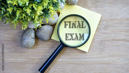 Ornamental trees, stones Small, magnifying glass, sticky note with text final exam