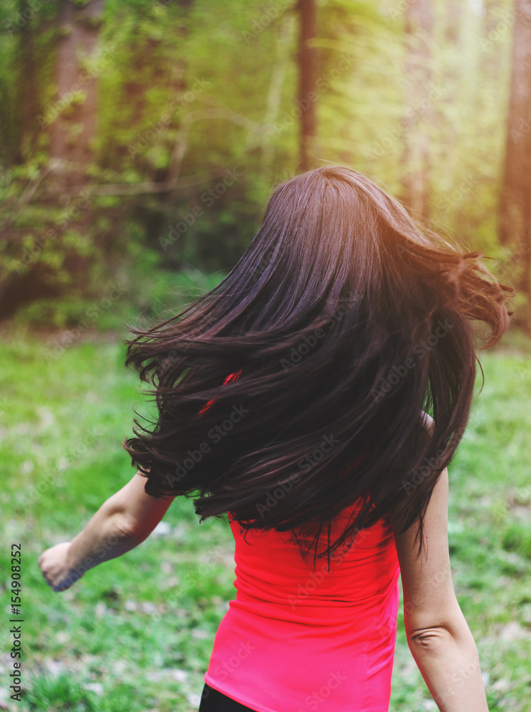 Attractive young brunette woman with gorgeous long hair outdoors enjoying nature. Motivation photo Attractive young brunette woman with gorgeous long hair outdoors enjoying nature. Motivation photo