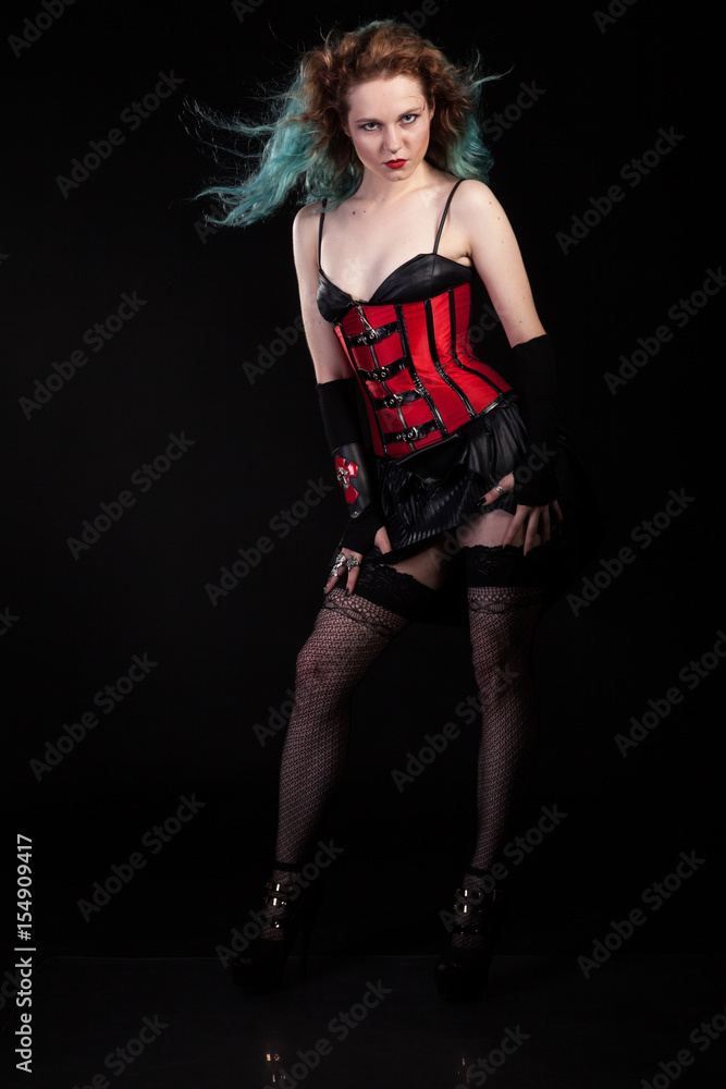 Beautiful woman in fetish red leather corset on black background in studio  photo. BDSM and dominatrix Stock Photo | Adobe Stock