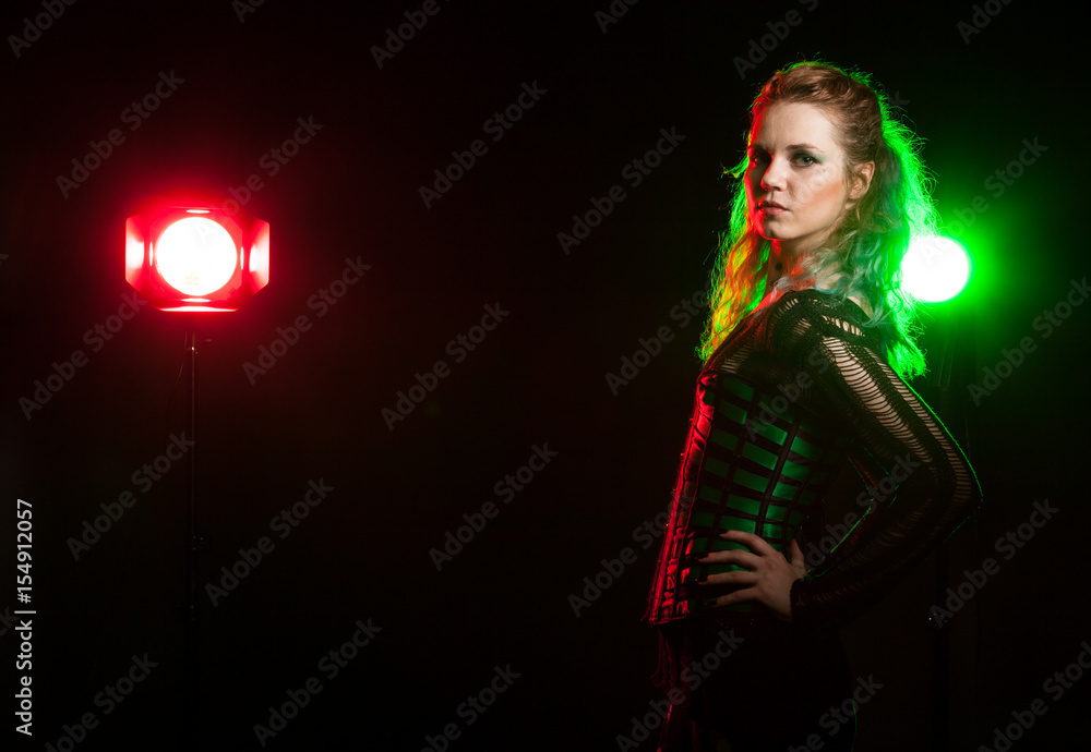 Cosplay model in corset in studio photo with a red and green light from behind. Cosplay and subculture Cosplay model in corset in studio photo with a red and green light from behind. Cosplay and subculture