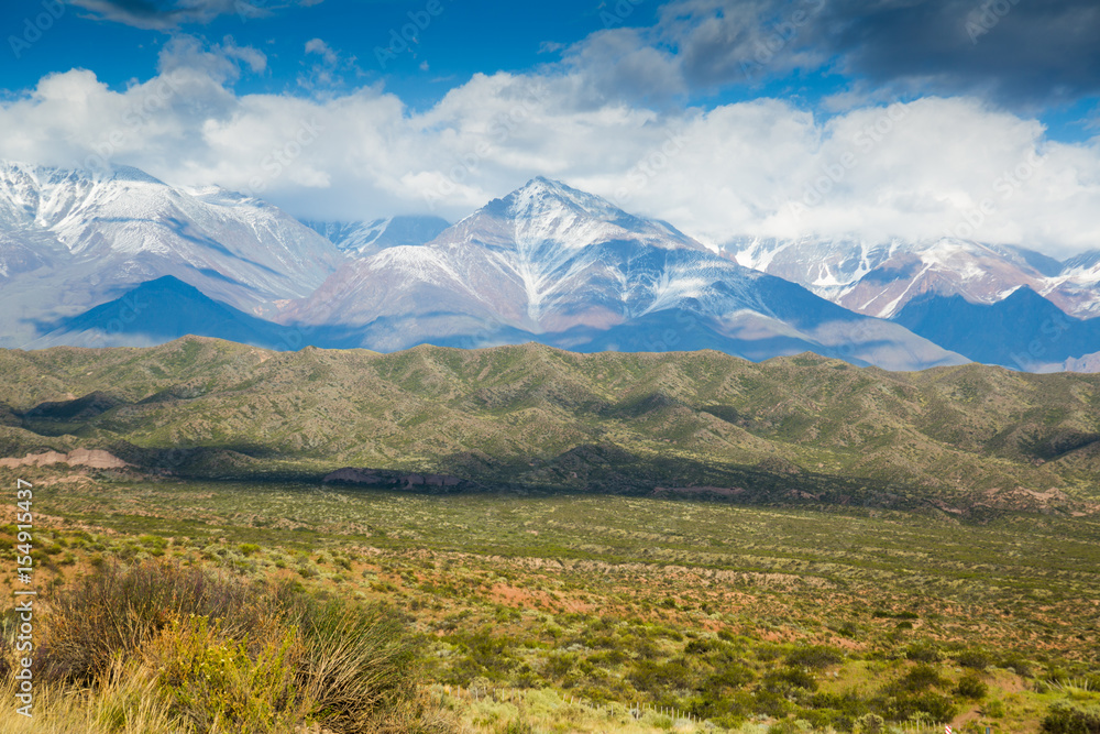 View of Andes mountains from green valley