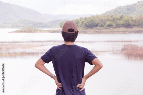 Traveler man standing in front of beautiful lake. © ilovewinter
