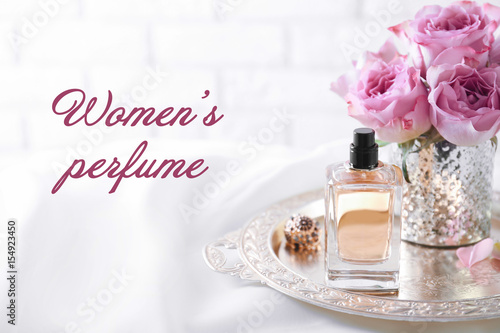 Women's perfume. Tray with bottle of scent on dressing table