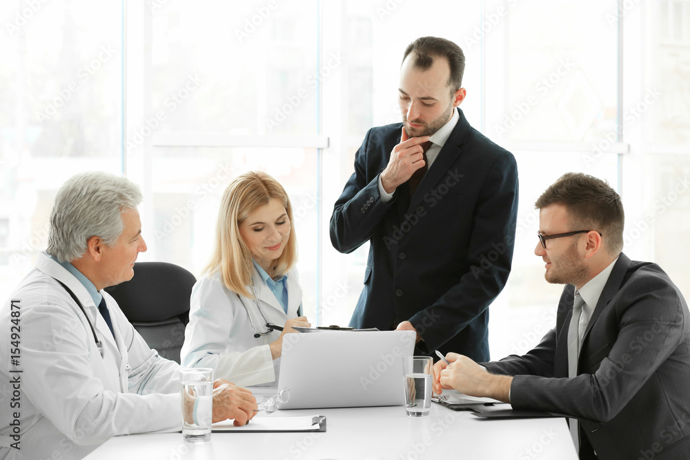 Team of doctors having consultation in clinic Team of doctors having consultation in clinic