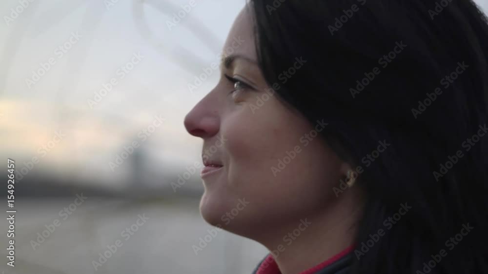 a Woman Stands on the Bank of the River, Look Forward and Smile at Sunset Large a Woman Stands on the Bank of the River, Look Forward and Smile at Sunset Large