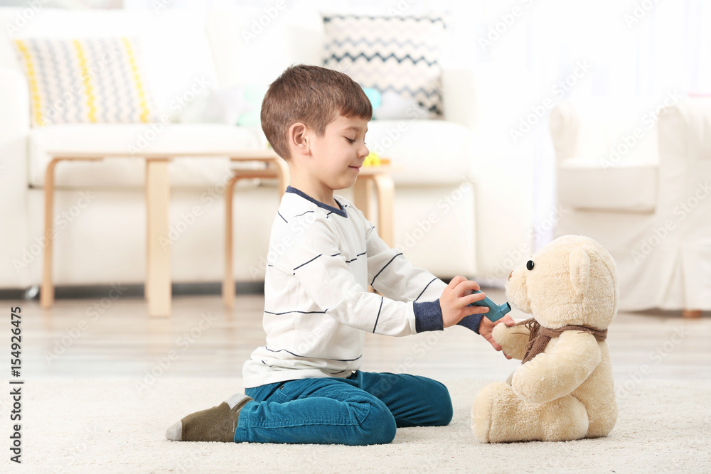 Cute little boy playing with inhaler at home. Allergy concept Cute little boy playing with inhaler at home. Allergy concept