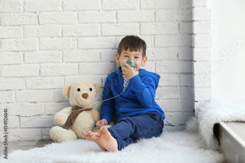 Little boy using nebulizer ...