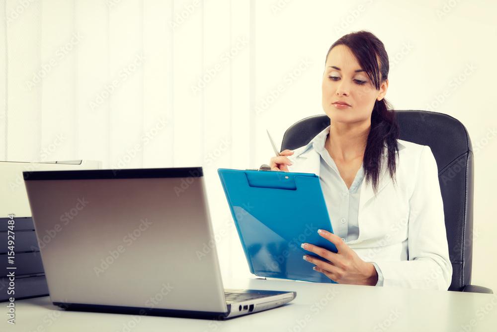 Young attractive business woman using laptop at the office Young attractive business woman using laptop at the office