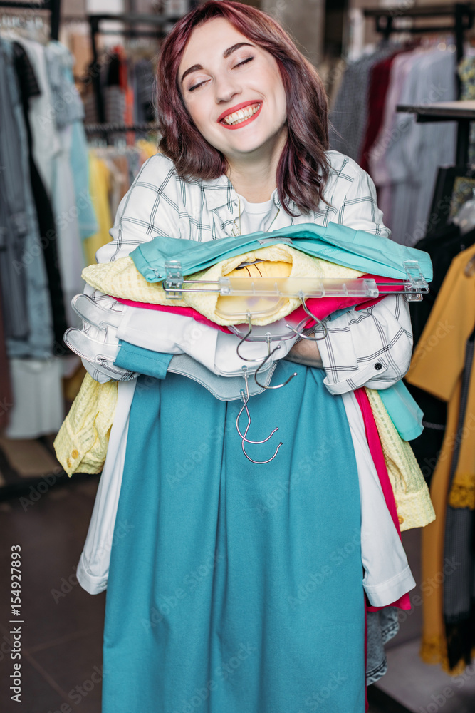 young hipster girl smiling in boutique, clothes shopping concept