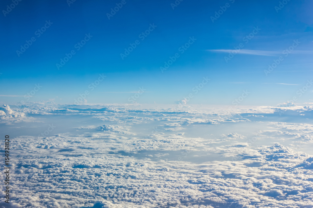 upper clouds view out of airplane - blue sky cloudscape