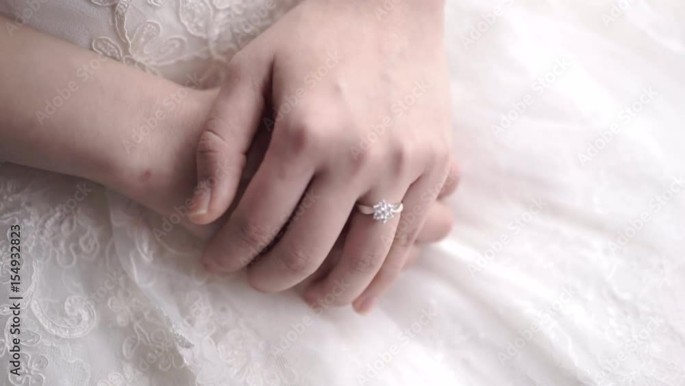 A bride wearing wedding ring sitting and waiting. Close up of a wedding ring. A bride wearing wedding ring sitting and waiting. Close up of a wedding ring.