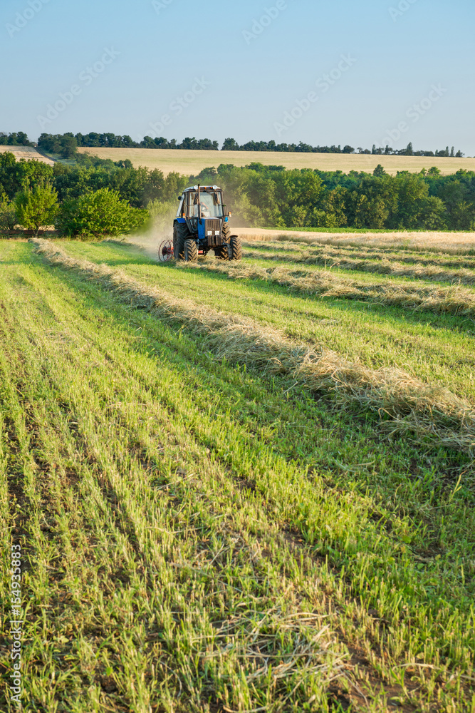 Tractor working on the farm field Tractor working on the farm field