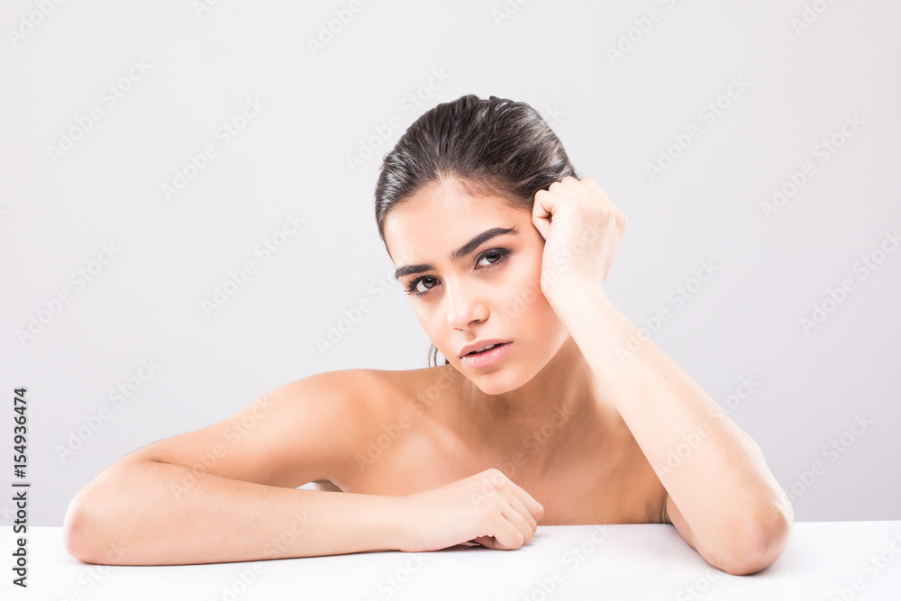 Portrait of young and beautiful woman face skin over grey. Healthcare and cosmetics Portrait of young and beautiful woman face skin over grey. Healthcare and cosmetics