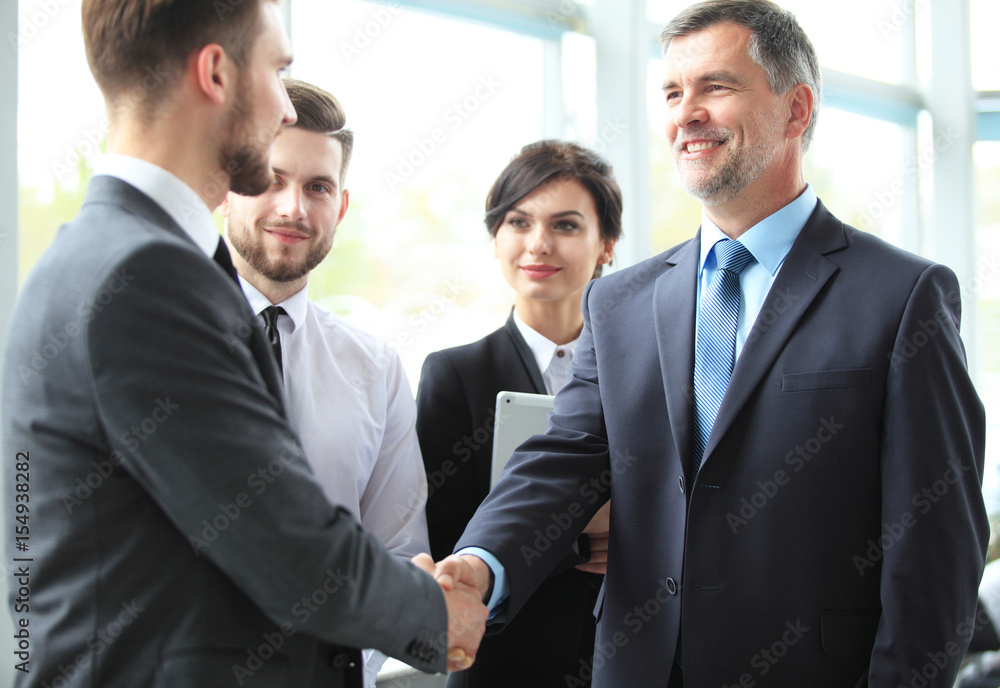 Business people shaking hands, finishing up a meeting. Business people shaking hands, finishing up a meeting.