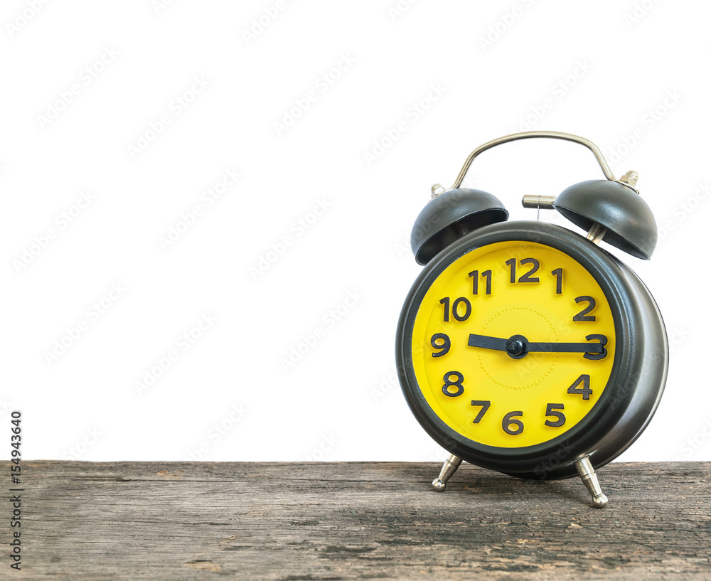 Closeup black and yellow alarm clock for decorate show a quarter past nine  o'clock or 9:15 a.m. on old brown wood desk isolated on white background  with copy space foto de Stock