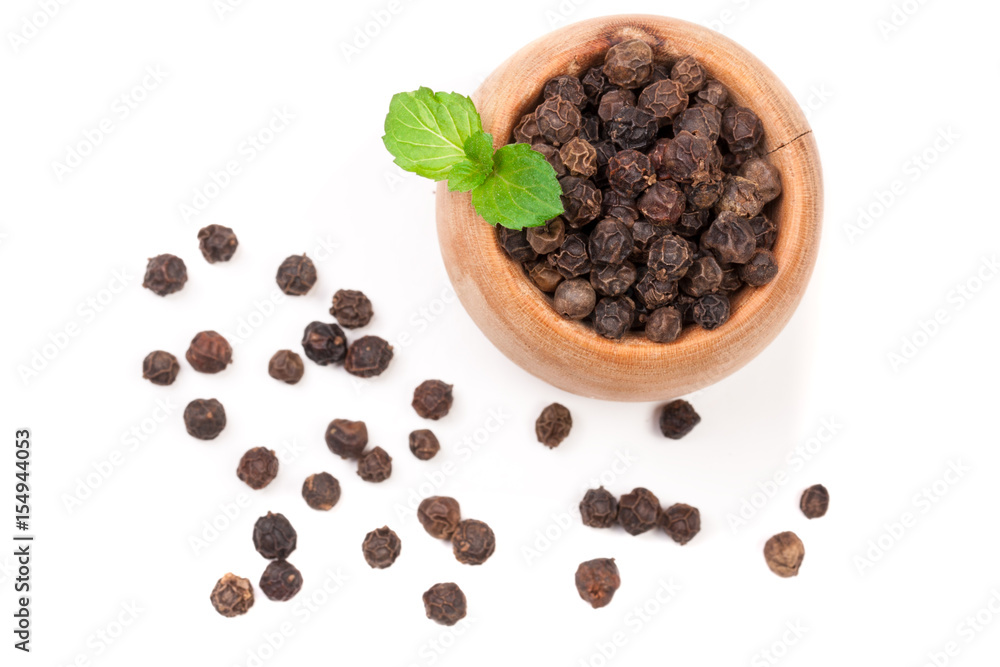 Black peppercorn in a wooden spoon isolated on white background. Top view Black peppercorn in a wooden spoon isolated on white background. Top view
