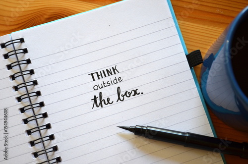 THINK OUTSIDE THE BOX written in notebook