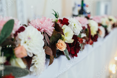 Fototapeta Naklejka Na Ścianę i Meble -  The different flowers standing on the wedding table