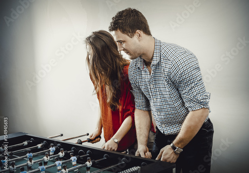 Friends playing table football.