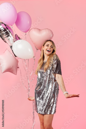 Laughing girl posing with balloons