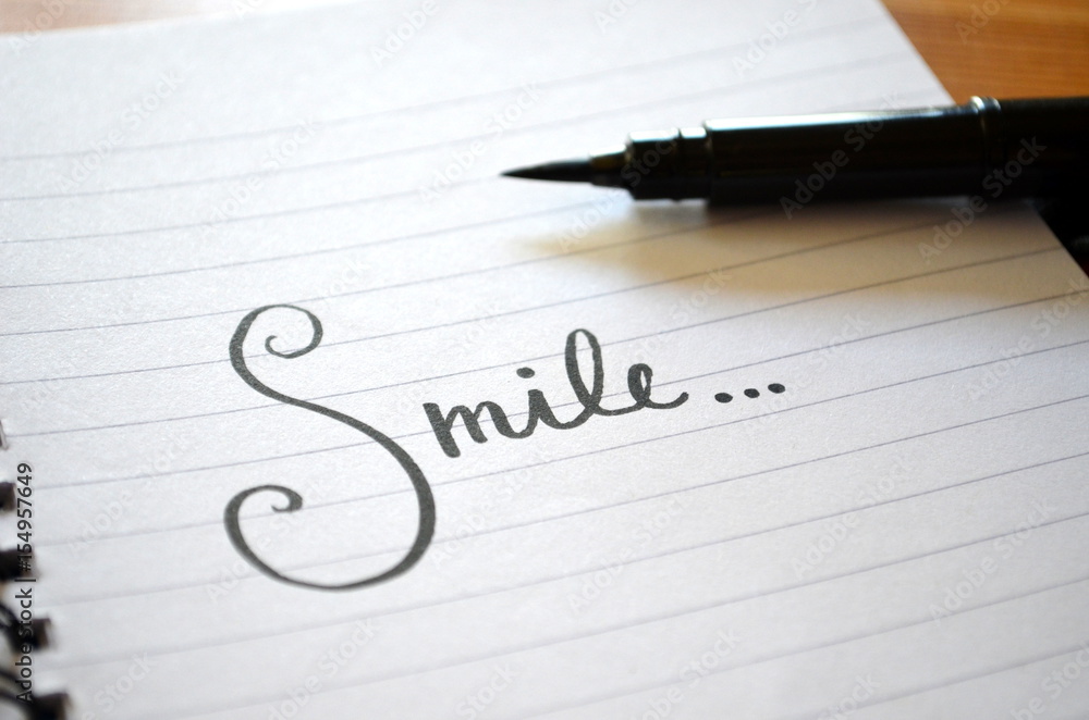 “Smile…” hand lettered in notebook “Smile…” hand lettered in notebook