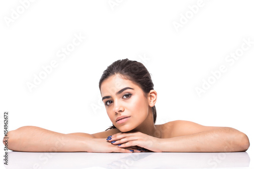 beautiful young smiling latina lying on the white. Skin  cosmetology.