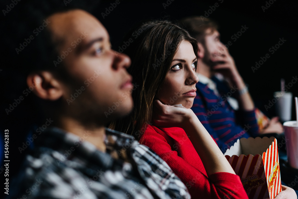 Young woman not liking the movie she is watching