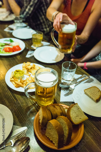 cold mug of beer with different snack photo