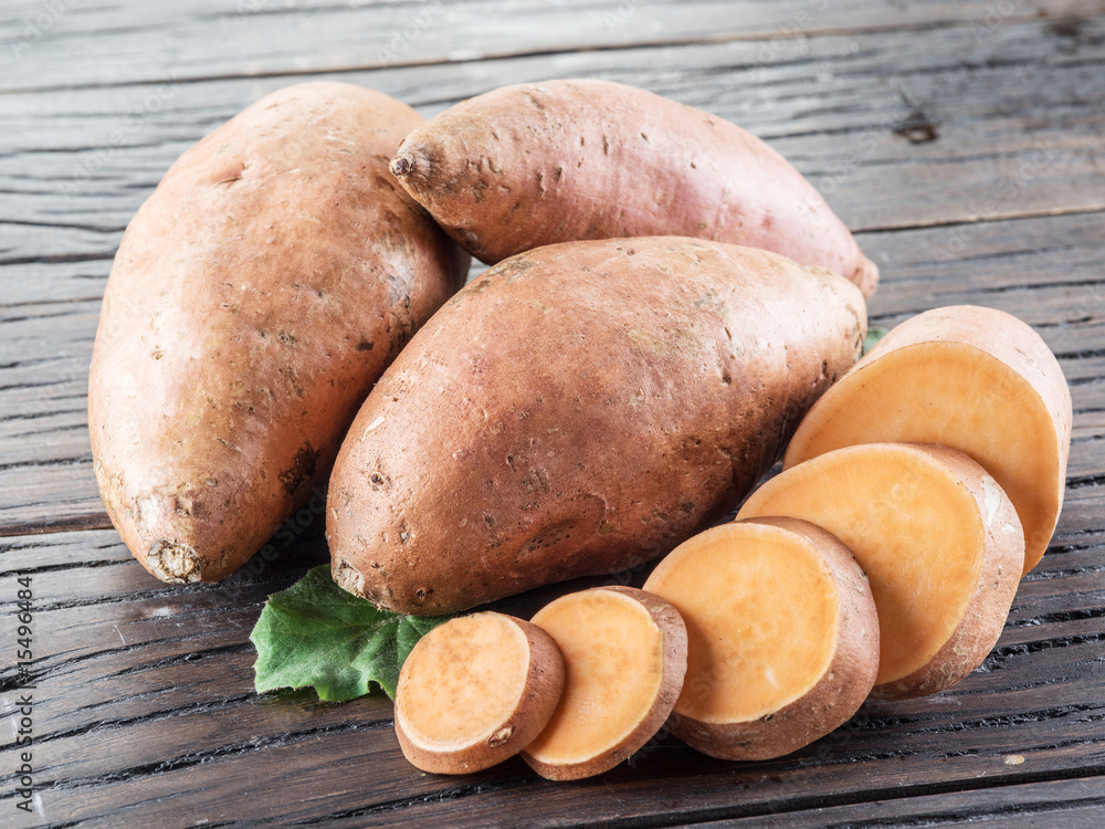 Sweet potatoes on the old wooden table. Sweet potatoes on the old wooden table.