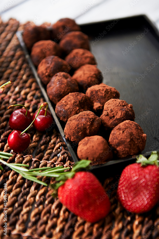 A lot of delicious round chocolate truffles. A work of culinary art A lot of delicious round chocolate truffles. A work of culinary art
