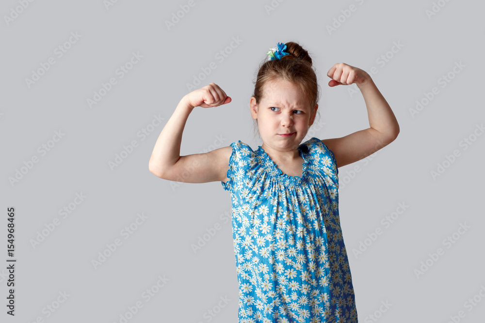 A little girl shows how strong her hands A little girl shows how strong her hands