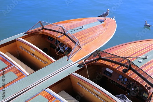 Принти на полотні Two classic wooden speedboats moored in blue water ready to take passengers on a