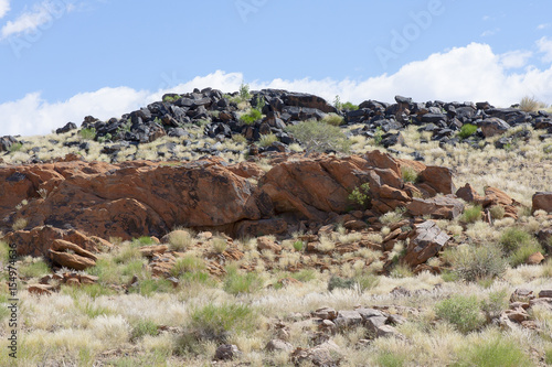 Black and red rocks in the area bordering the Orange River canyon at Augrabies Falls in South Africa. These rocks contain iron and manganese ores.
