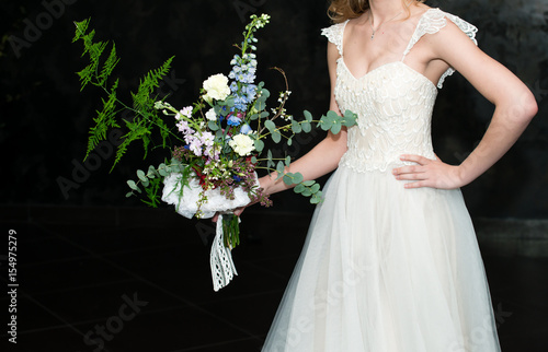 modern wedding bouquet in hands of bride copy space