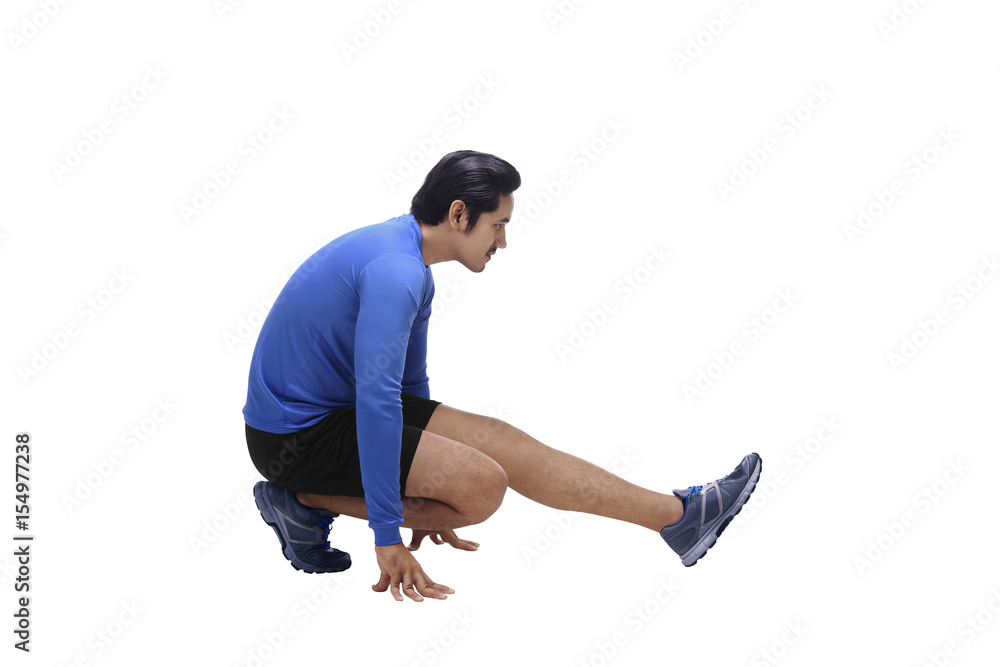 Handsome asian man athlete doing stretching legs before running