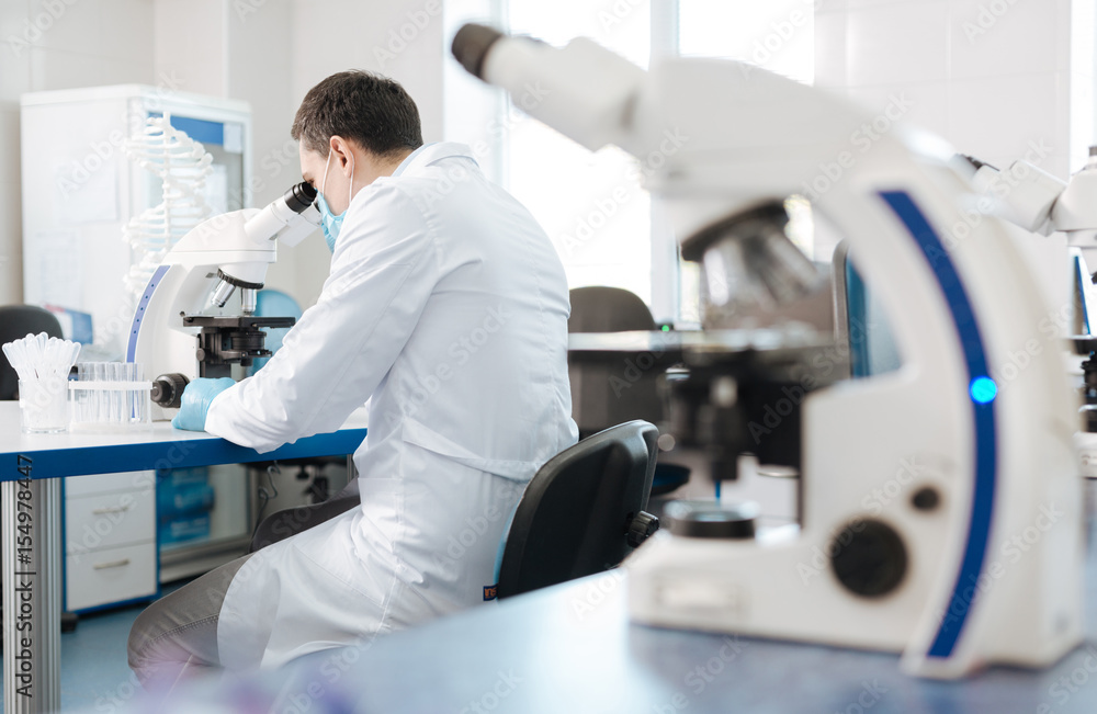 Confident researcher looking into ocular Confident researcher looking into ocular