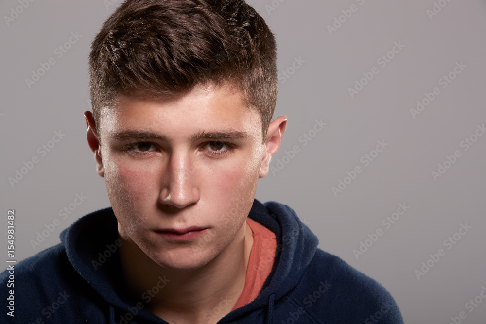 Teenage boy with serious expression, head and shoulders Teenage boy with serious expression, head and shoulders
