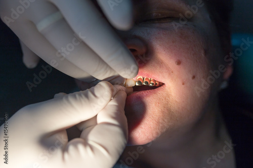 The dentist works with the client in the clinic