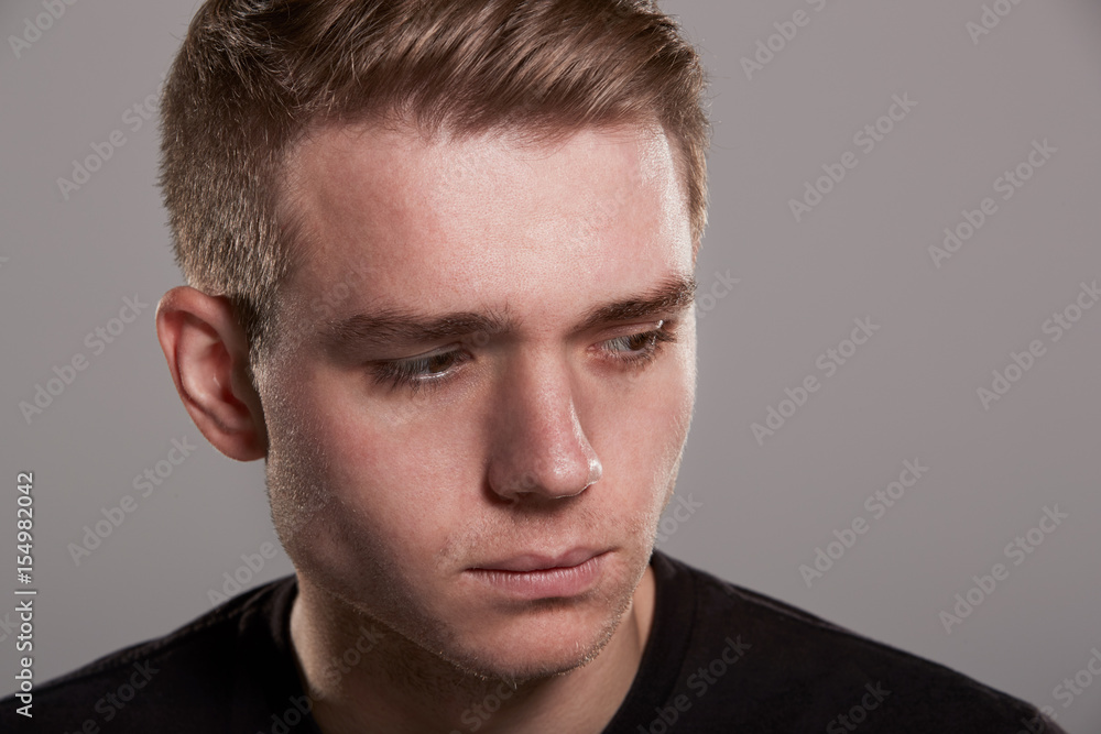 Sad young white man looking away, head and shoulders Sad young white man looking away, head and shoulders