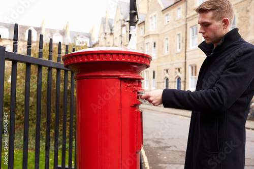 Canvas Print Man Posting Letter In Red British Postbox