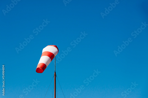 Airport windsock on clear blue sky background