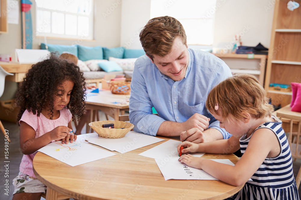 Teacher And Pupils Practicing Writing In Montessori School Teacher And Pupils Practicing Writing In Montessori School