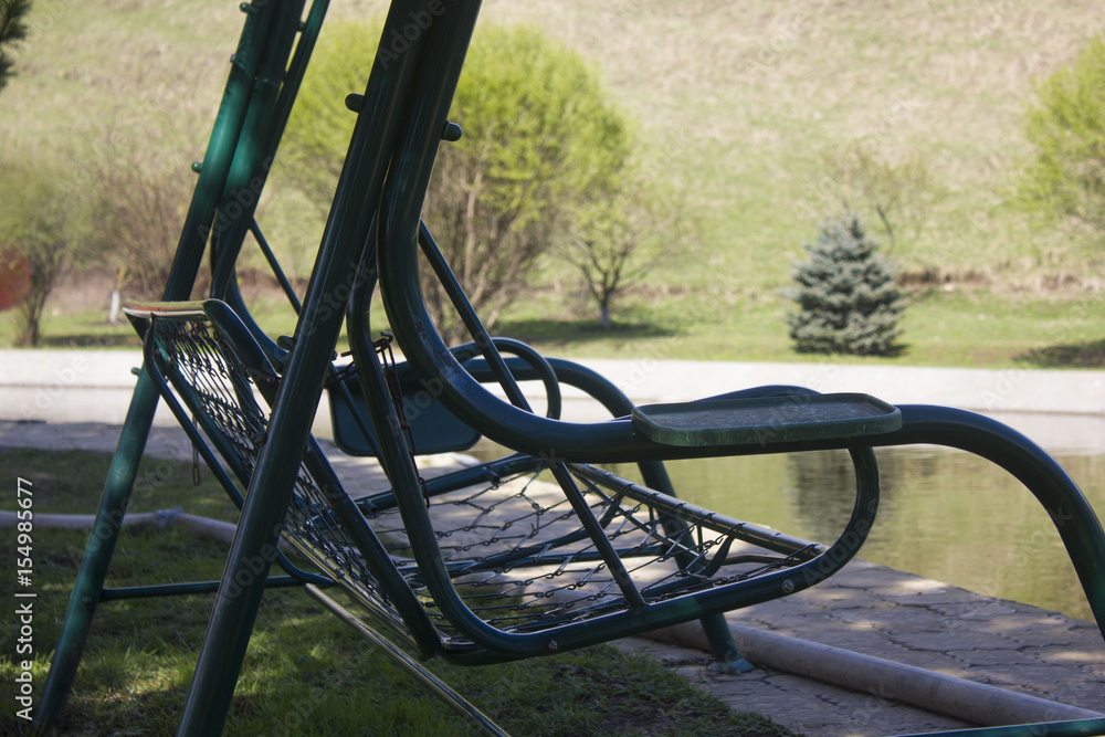 a swinging bench on the background of the lake a swinging bench on the background of the lake