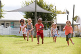 Children At Montessori School Having Fun Outdoors During Break