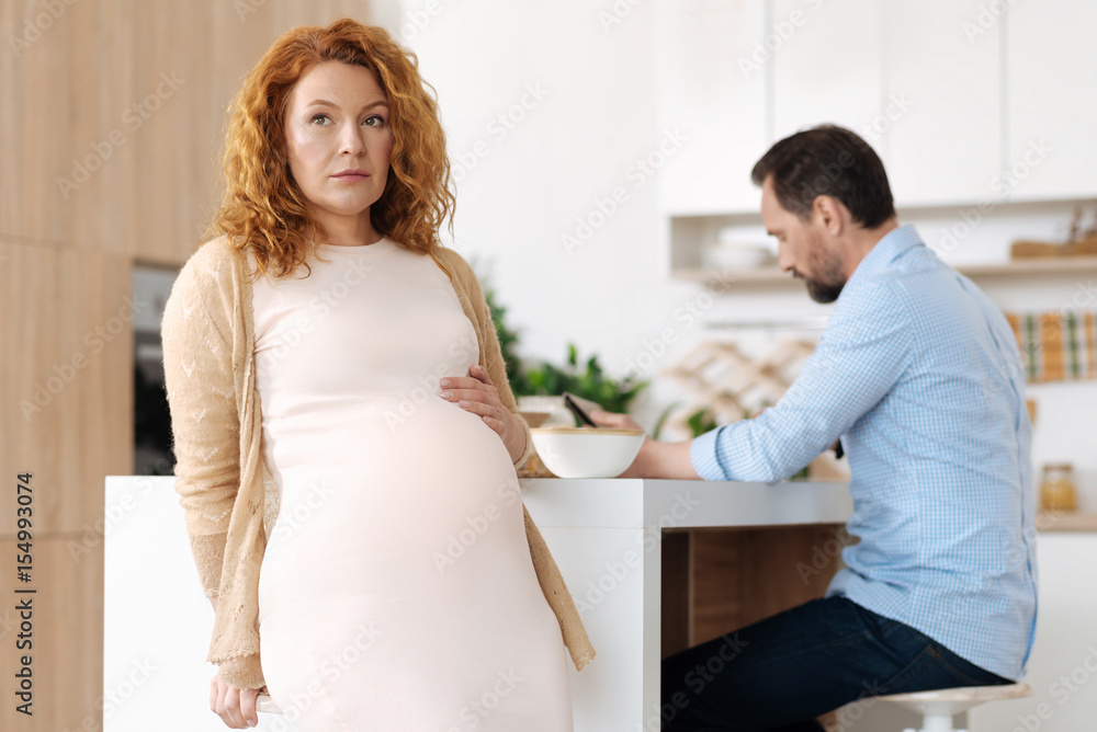 Beautiful full term pregnant woman pondering issues